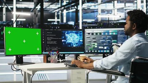 Data center admin in wheelchair using AI node tree software on green screen PC Stock-Fotos