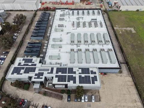 Data center building with solar panels and cooling infrastructure Stock Photos