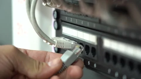 Data center cable. A person inserts a patch cord. Stock Footage 217470874