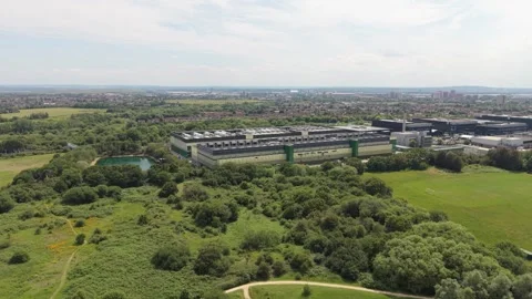 Data Center Campus Aerial Perspective With Lush Parkland and Distant City Stock Footage 339645447