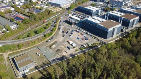 Data Center Campus Development near Frankfurt with Passing Train – Aerial View Stock Footage 346907352