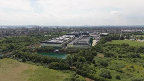 Data Center Campus With Green Fields, Pond, and Distant City View Stock Footage 339645283