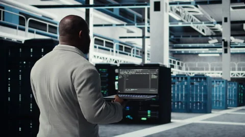 Data center computer scientist coding on laptop, doing software updates Stock Footage 311897592