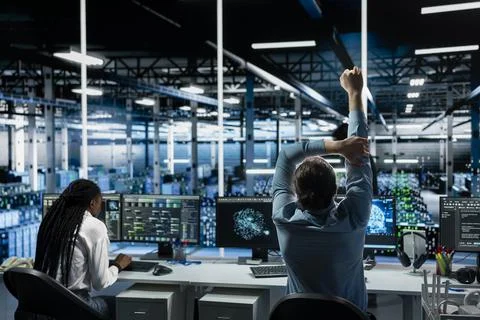 Data center computer scientist relaxing joints to combat sedentary fatigue Stock Photos