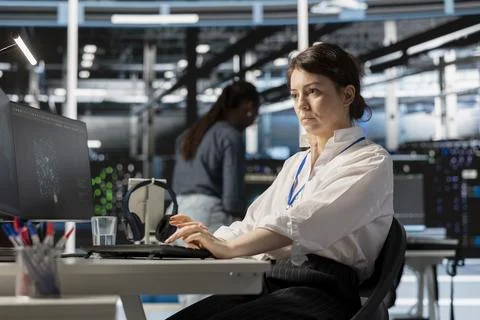 Data center computer scientist uses PC to update servers tech Stock Photos