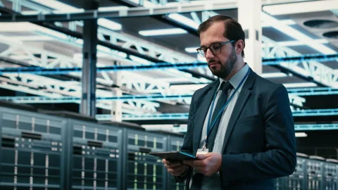 Data center computer scientist using tablet app, managing equipment Stock Footage 329945221