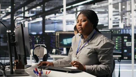 Data center computer scientist using PC to monitor artificial intelligence Stock Photos