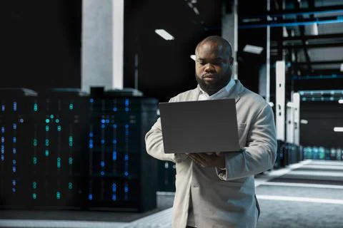 Data center computer scientist using laptop to protect servers Stock Photos
