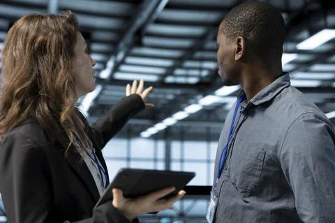 Data center computer scientists using laptop, conducting security audits, Foto stock