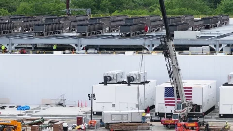 Data center construction site with dense rooftop cooling units, large crane Stock Footage 337691813