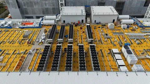 Data center cooling systems on industrial building rooftop Stock Photos
