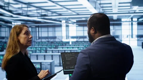 Data center coworkers doing yearly maintenance using laptop and tablet Stock Footage 277655135