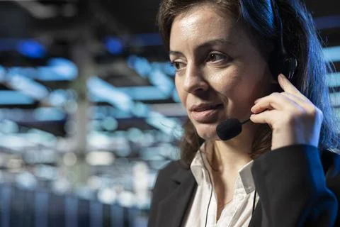 Data center customer support operator helping users, speaking into headset mic Stock Photos