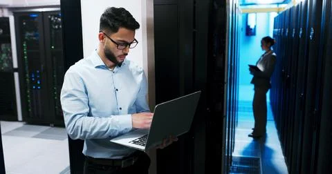 Data center, cybersecurity and man with laptop, coding and network engineer with Stock-Fotos