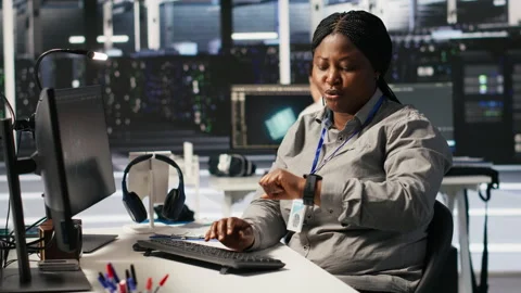 Data center developer doing software updates, looking at watch Stock Footage 309638330