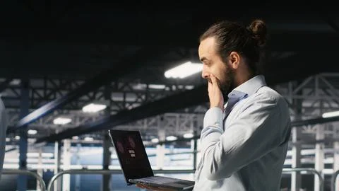 Data center developer frustrated by critical error affecting laptop Stock Photos