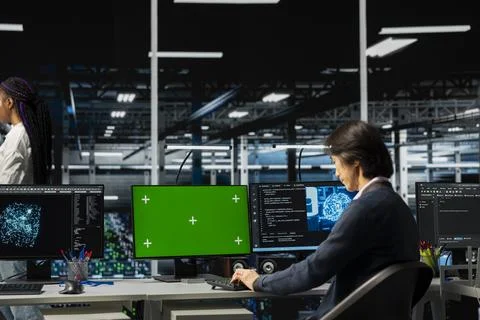 Data center developer using chroma key PC, adjusting AI model parameters 写真素材