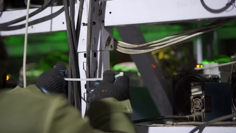 Data center diagnostics technician doing asic mining equipment racks cable Stock Footage 130060298