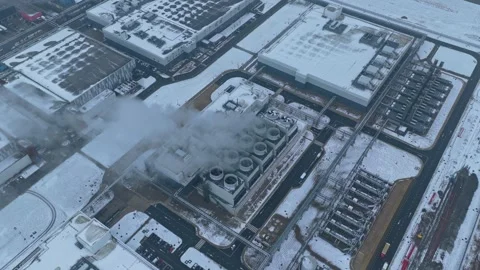 Data center emitting steam during a cold winter day aerial view Stock Footage 327904233