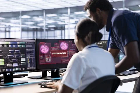 Data center employee requesting aid from supervisor to mitigate security risks Stock Photos