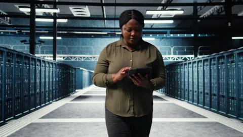 Data center employee uses tablet to manage software updates for system stability Stock Footage 317202983