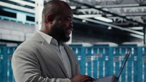 Data center engineer deploying AI driven management tools using laptop Stock Footage 311960073