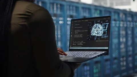Data center engineer doing AI data analysis on laptop to upgrade infrastructure Stock Photos