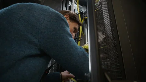 Data Center Engineer Maintaining Server Rack and Network Cables Stock Footage 330544197