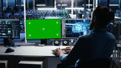 Data center engineer managing AI systems for uptime using mockup PC Stock Photos