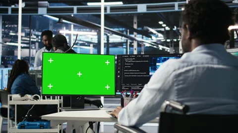 Data center engineer with paraplegia using AI algorithms on green screen PC Stock Footage 307038351