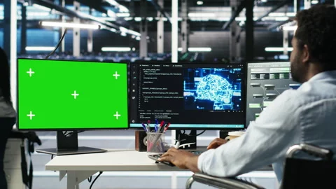 Data center engineer with paraplegia using AI algorithms on green screen PC Stock Footage 308044803