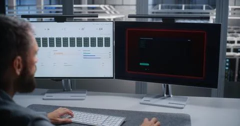 Data Center Engineer Responding to DDoS Attack and Monitoring Network Security Stock Photos