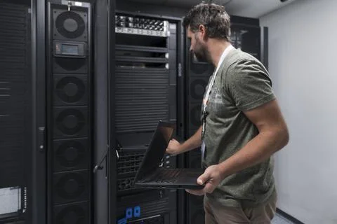 Data Center Engineer Usaing Keyboard on a Supercomputer Server Room Specialist Stock Photos