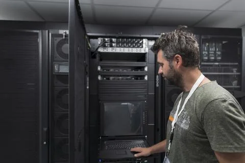 Data Center Engineer Usaing Keyboard on a Supercomputer Server Room Specialist Stock Photos