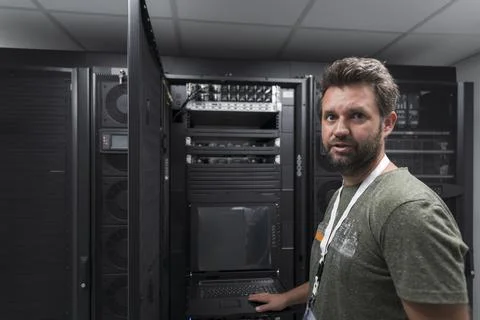 Data Center Engineer Usaing Keyboard on a Supercomputer Server Room Specialist Stock Photos