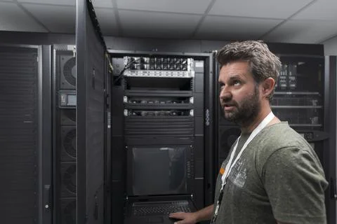 Data Center Engineer Usaing Keyboard on a Supercomputer Server Room Specialist Stock Photos