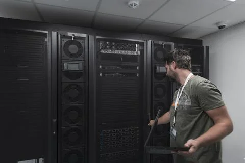 Data Center Engineer Usaing Keyboard on a Supercomputer Server Room Specialist Stock Photos
