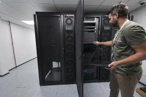 Data Center Engineer Usaing Keyboard on a Supercomputer Server Room Specialist Stock Photos