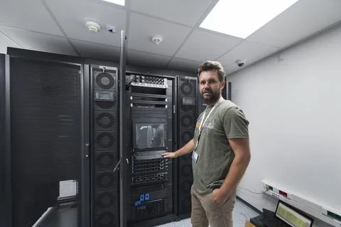 Data Center Engineer Usaing Keyboard on a Supercomputer Server Room Specialist Stock Photos