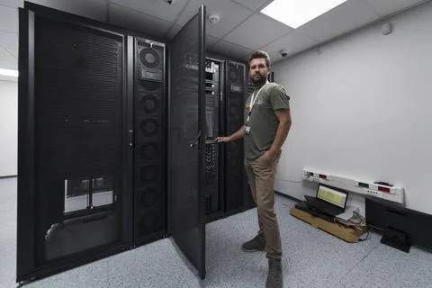 Data Center Engineer Usaing Keyboard on a Supercomputer Server Room Specia... Stock Photos