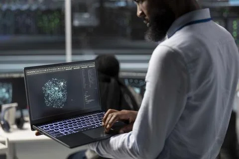 Data center engineer uses AI visualization tool on laptop Stock Photos
