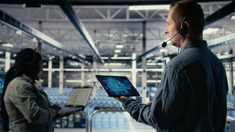 Data center engineer using AI on tablet to help clients resolve hosting problems Stock Footage 314683121