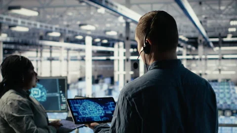 Data center engineer using AI on tablet to help clients resolve hosting problems Stock Footage 314685870
