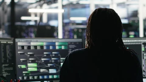 Data center engineer using algorithms to analyze datasets, putting on headphones Stockbeeldmateriaal 307021260