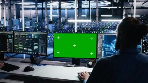 Data center engineer using green screen PC to monitor neural network using AI Stock Photos