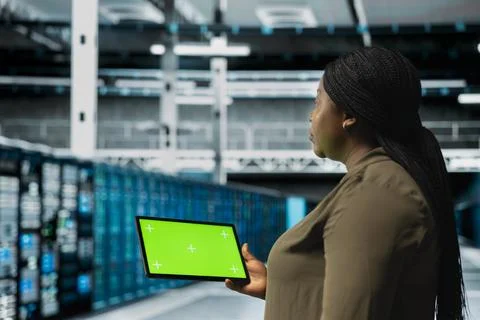 Data center engineer using green screen tablet to automate anomaly detection Stock Photos