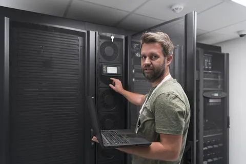 Data Center Engineer Using Laptop Computer Server Room Specialist Facility with Stock Photos