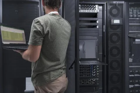 Data Center Engineer Using Laptop Computer Server Room Specialist Facility with Stock Photos