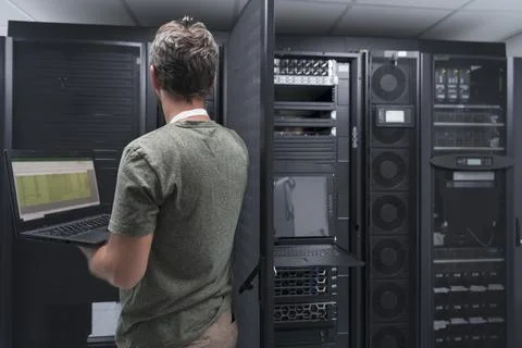 Data Center Engineer Using Laptop Computer Server Room Specialist Facility with Stock Photos