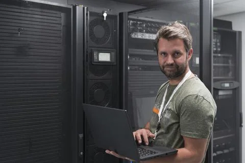 Data Center Engineer Using Laptop Computer Server Room Specialist Facility with Stock Photos
